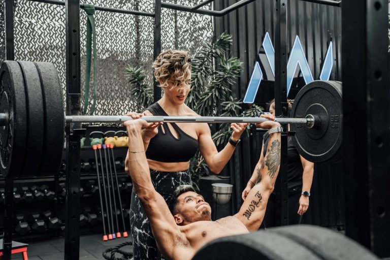man and woman over 40 strength training outdoors to boost metabolism