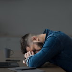 Adult waking up tired despite full night’s sleep due to poor sleep architecture and hormone imbalance.