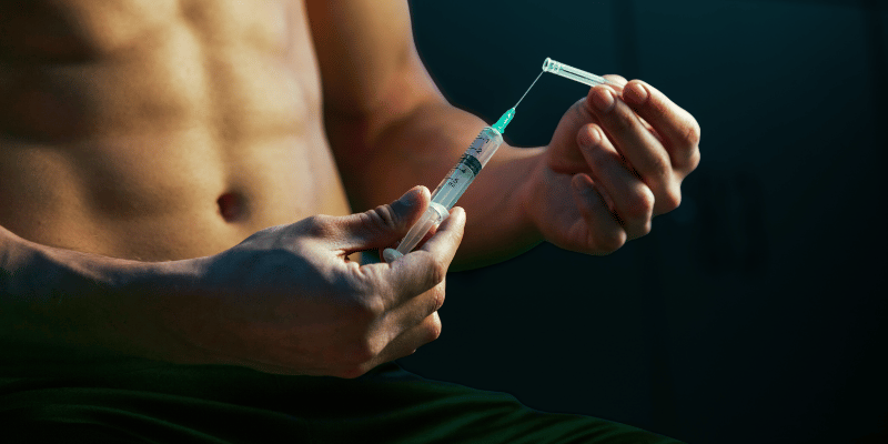 Man preparing a testosterone injection, illustrating medical TRT options for men over 40.