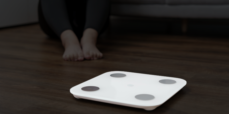 athroom scale symbolizing frustration with stalled fat loss in adults over 40