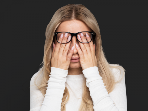 Adult rubbing eyes during evening hours due to cortisol inversion and difficulty winding down at night.