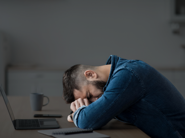 Adult waking up tired despite full night’s sleep due to poor sleep architecture and hormone imbalance.